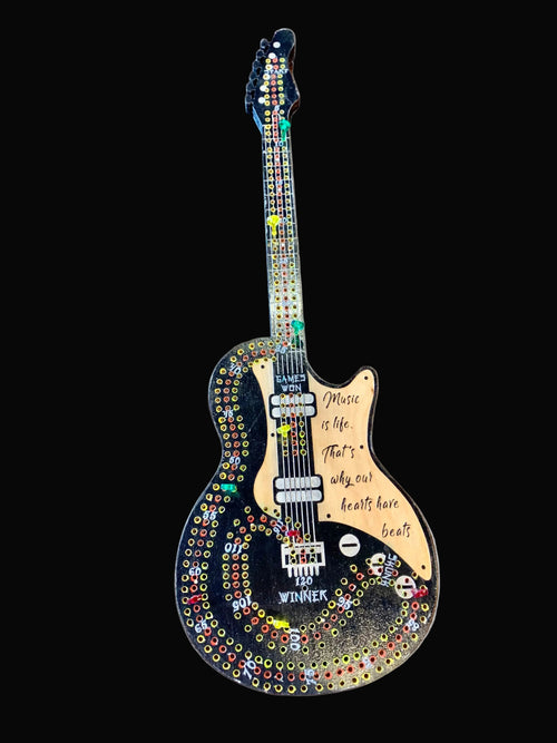 Decorative guitar cribbage board hand painted on a wooden surface