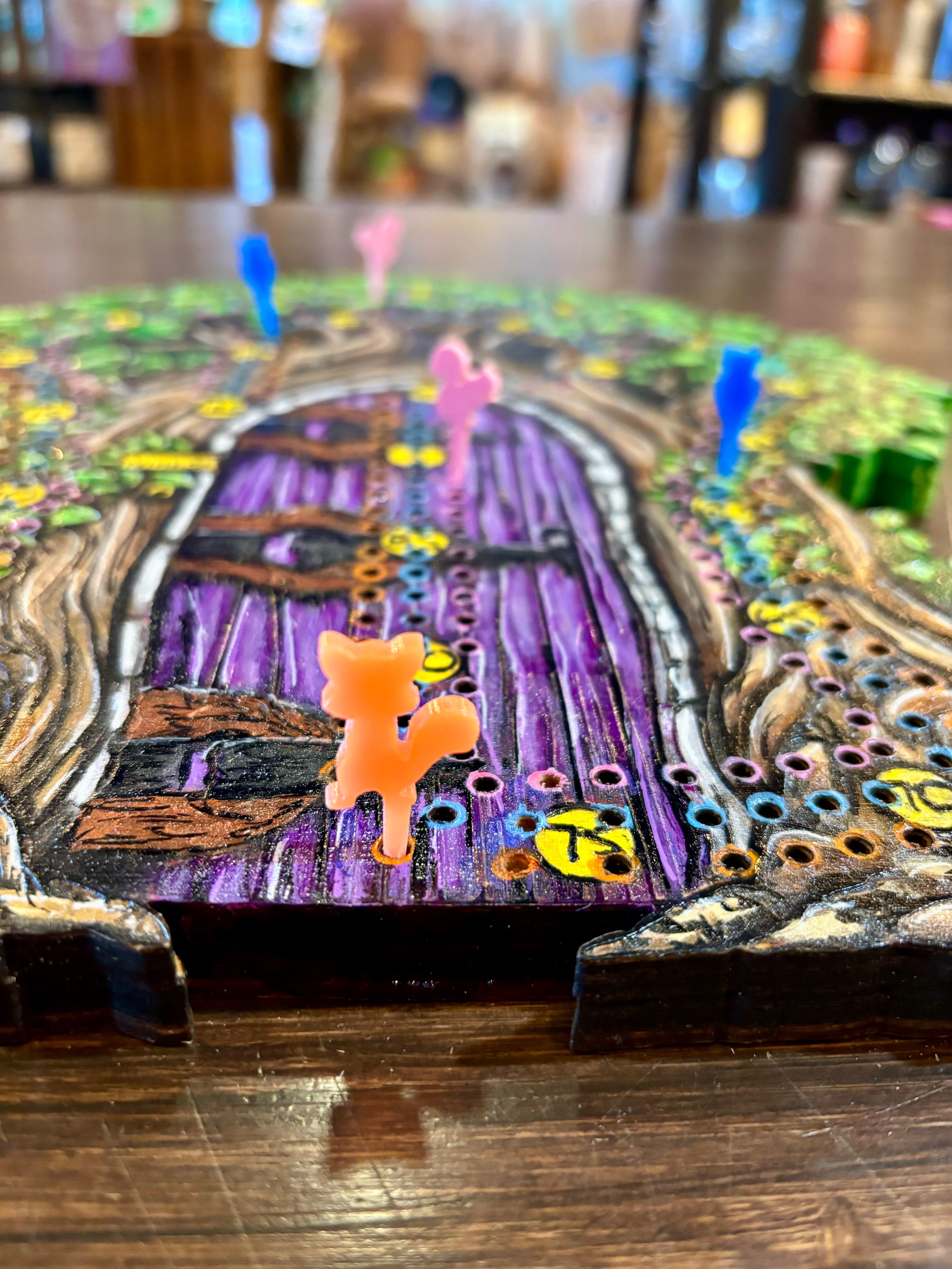 Board game piece on a colorful board with a purple door
