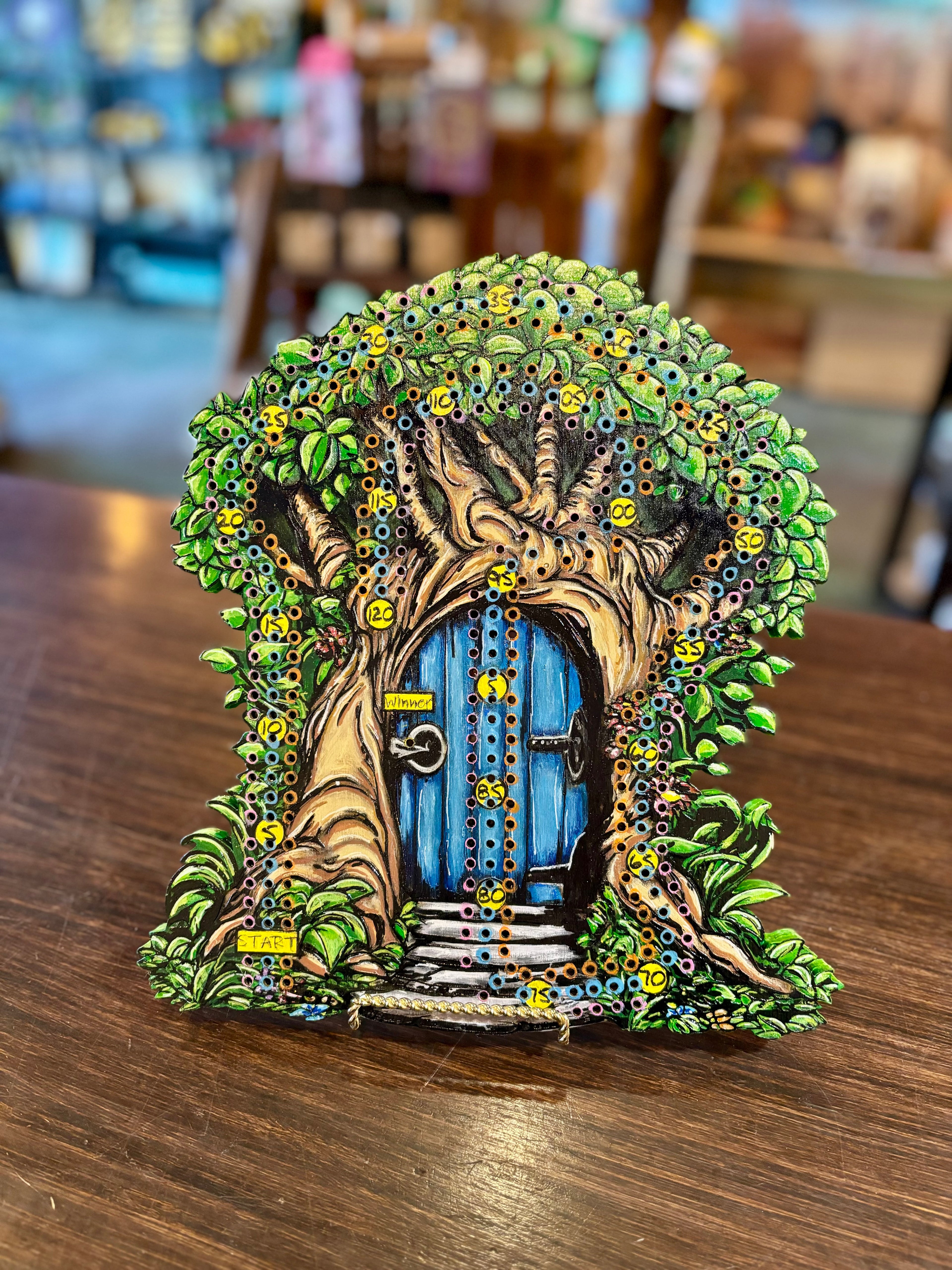 Fantasy door in a tree with blue door and greenery on a cribbage board