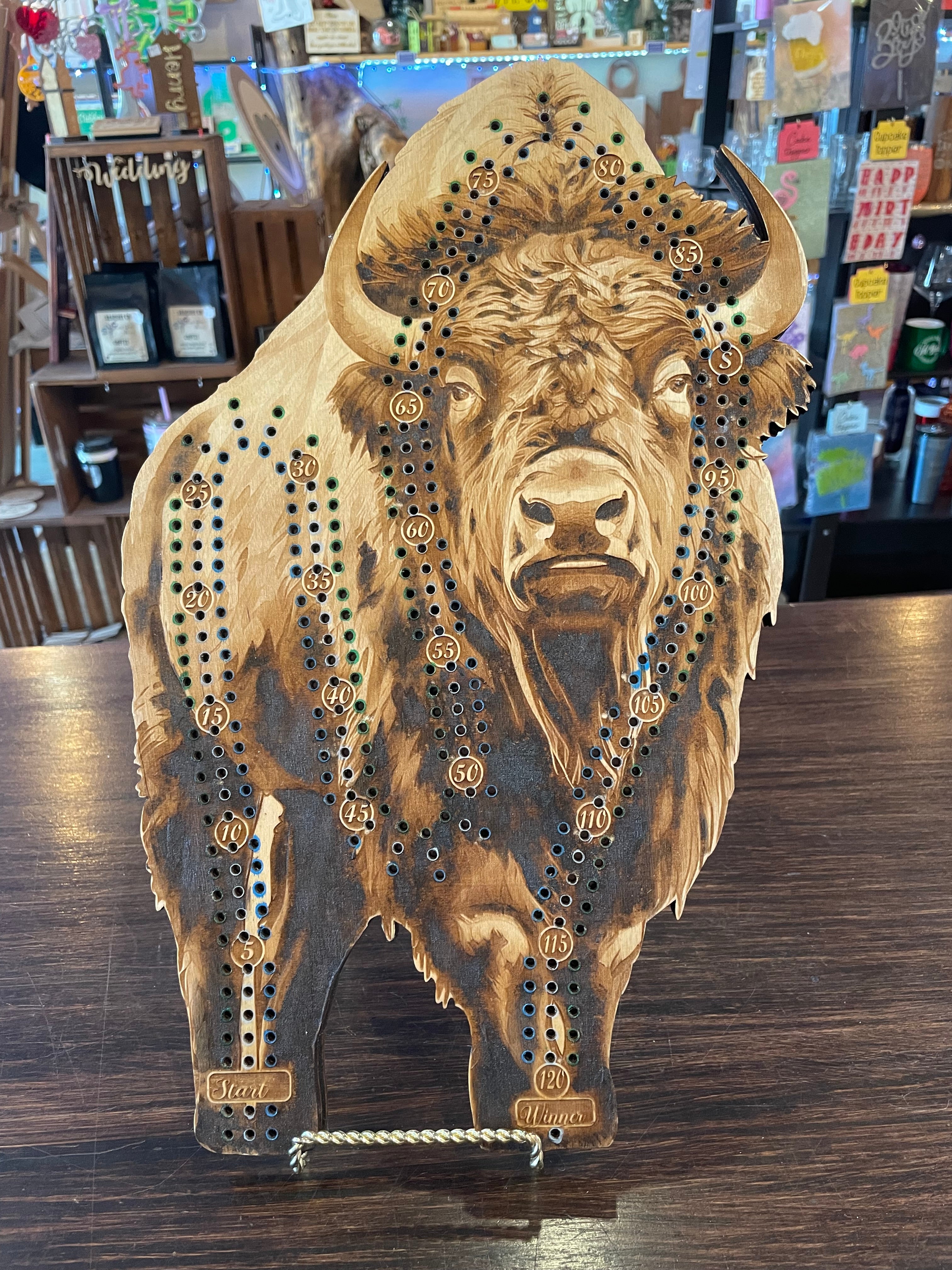 Wooden crib board with buffalo design.