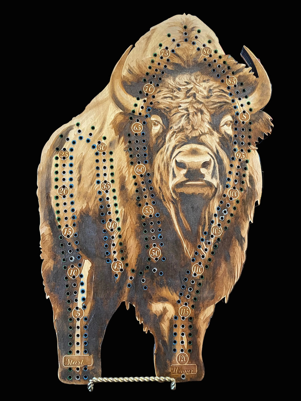Wooden cribbage board with bison design.