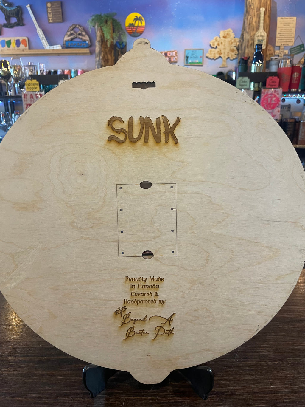 Back of wooden crib board with 'SUNK' branding and crib pegs removalable holder