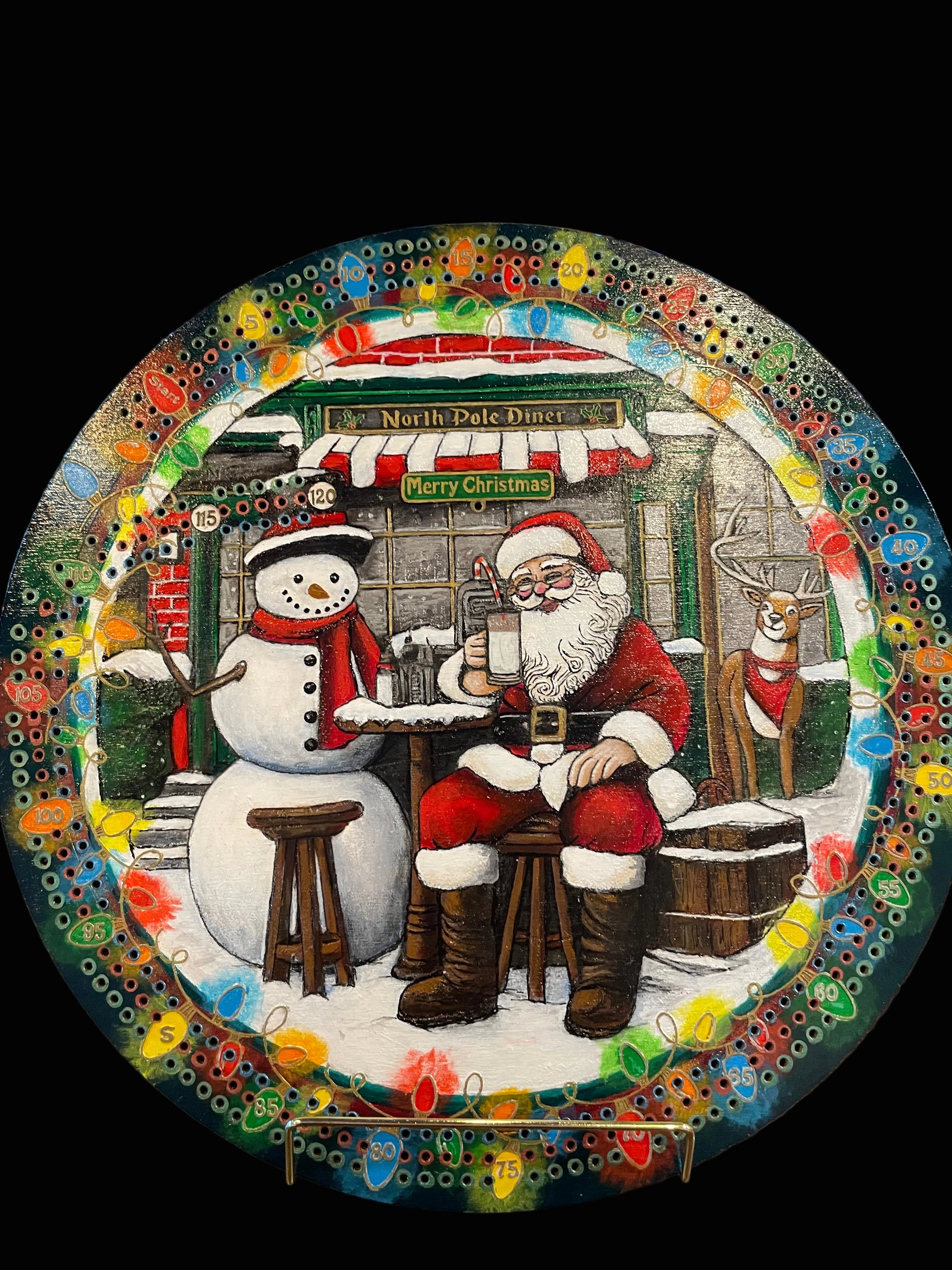 Decorative cribbage board with Santa Claus and snowman design.
