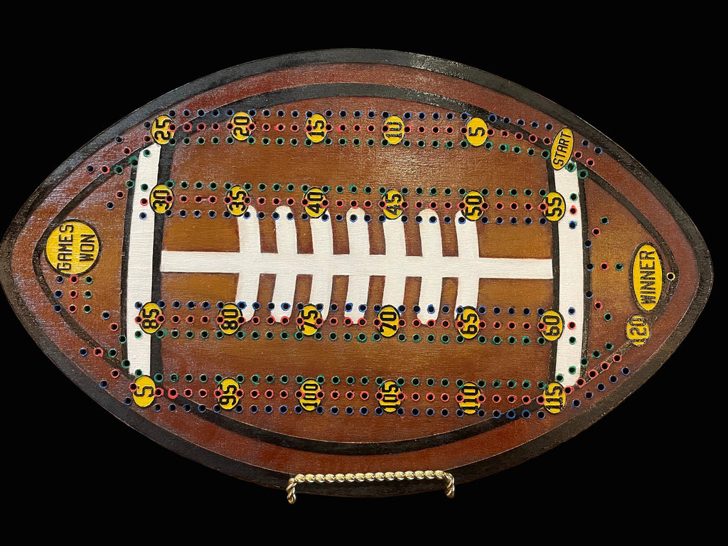 Wooden cribbage board shaped like a football.