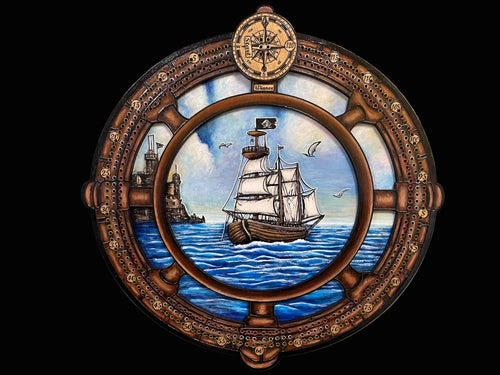 Decorative cribbage board with a ship in the sea scene.