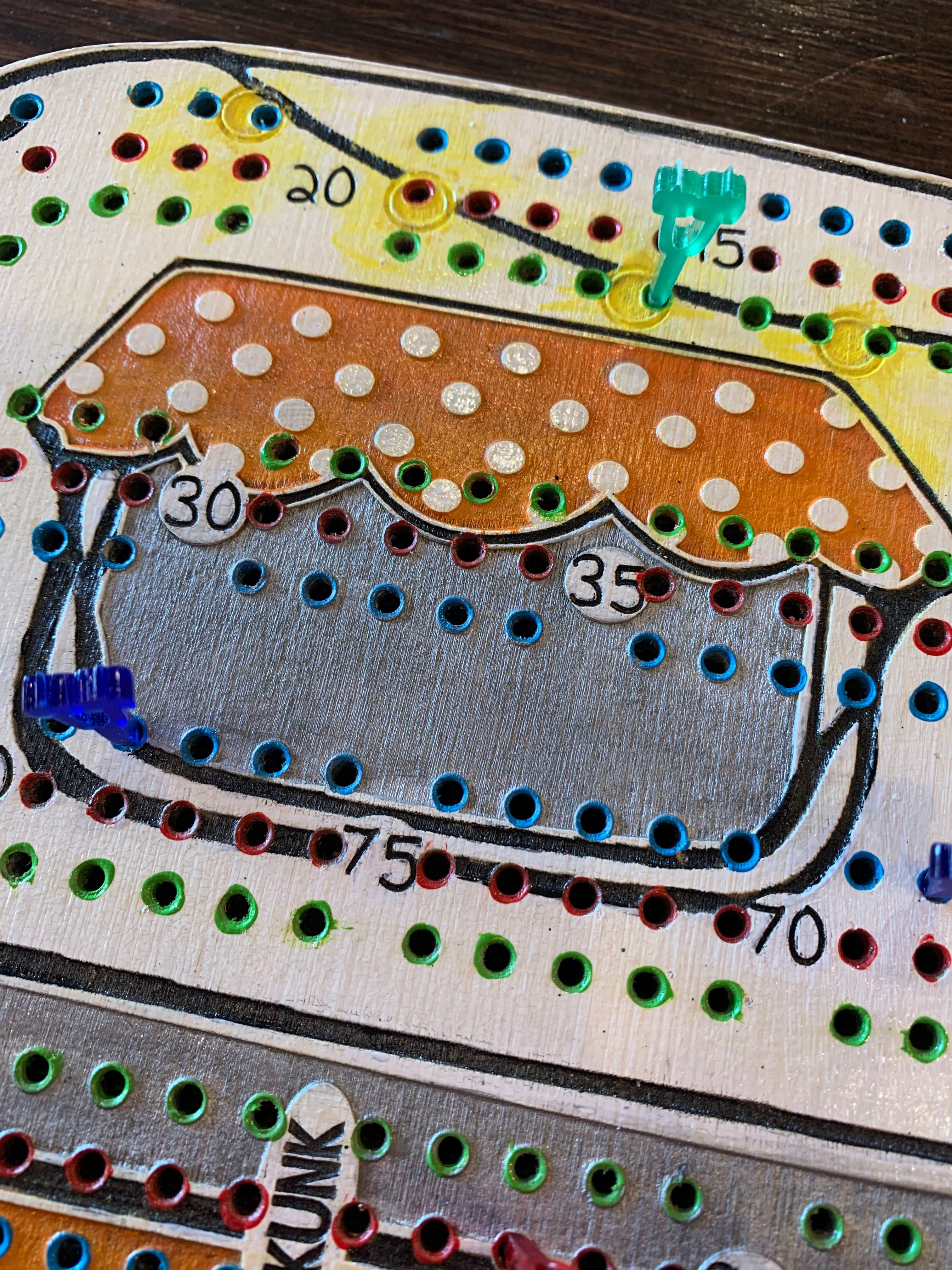 Close-up of a handcrafted wooden board game piece.
